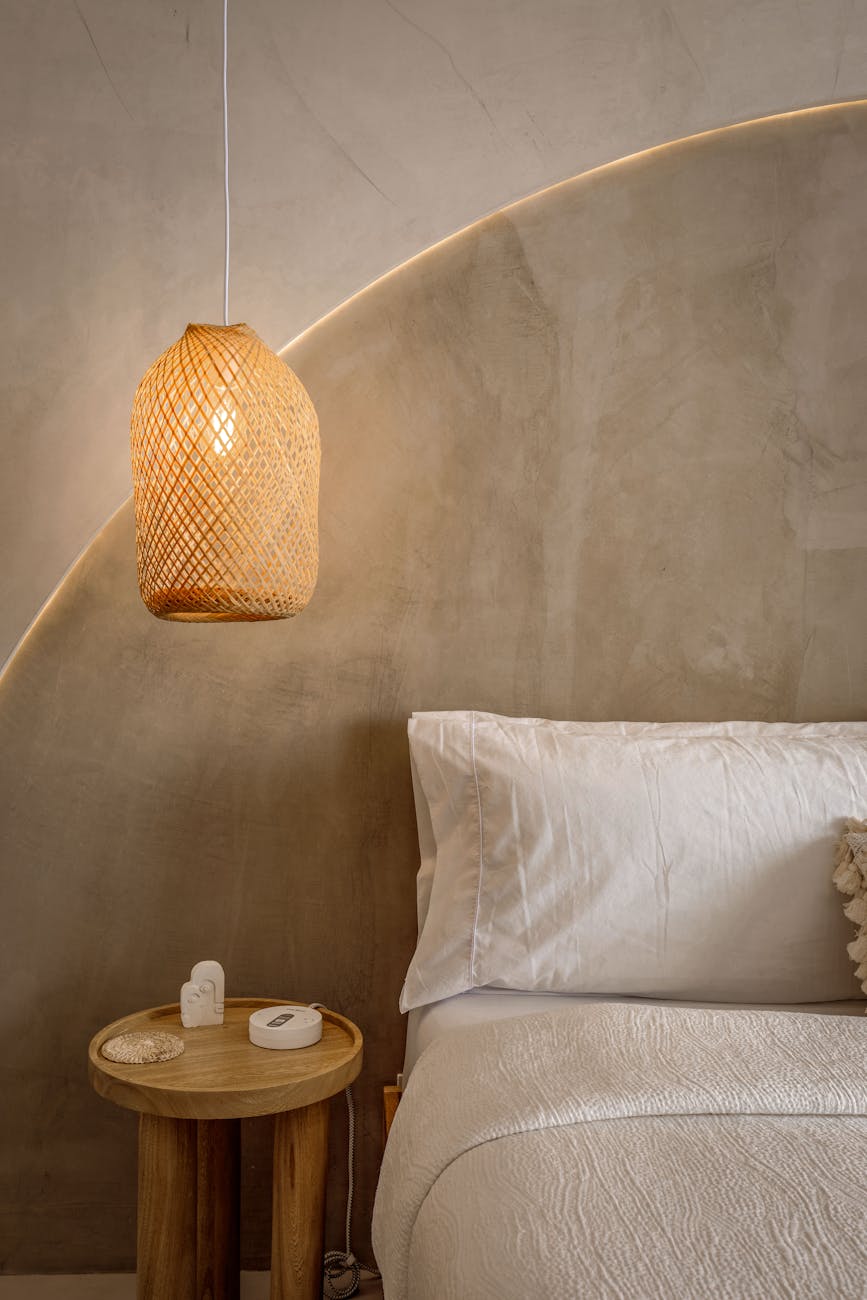 cozy minimalist bedroom with woven lamp